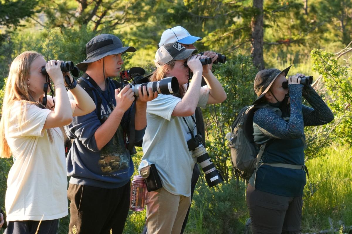 students looking through binoculars