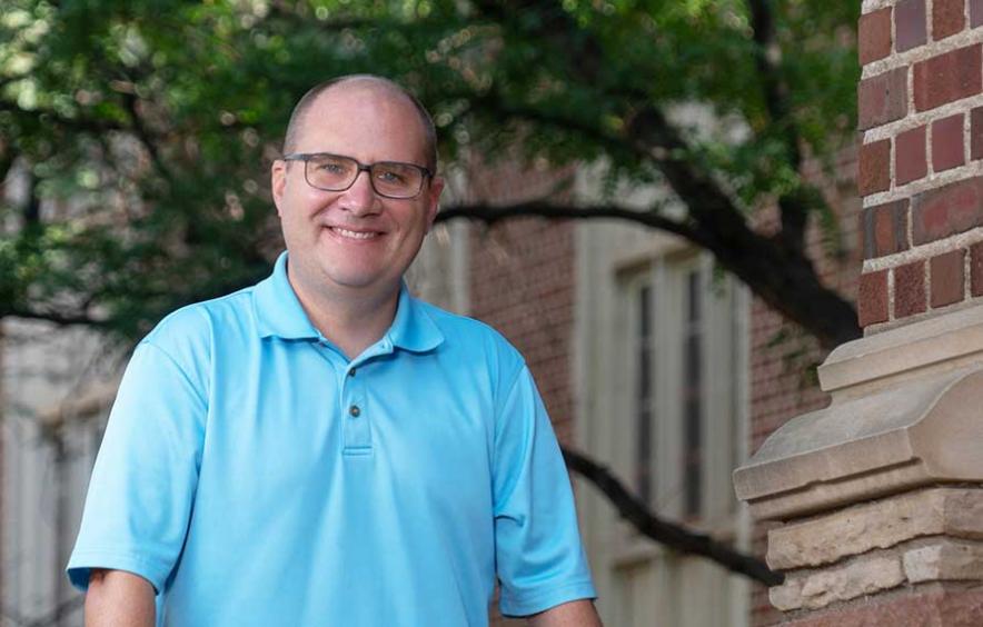 nic ormes standing outside of academic buildings