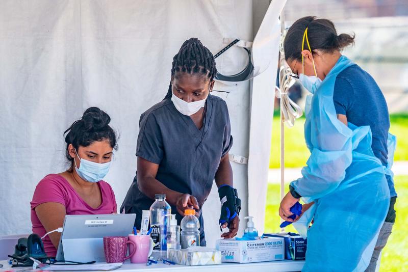 Three people performing COVID testing