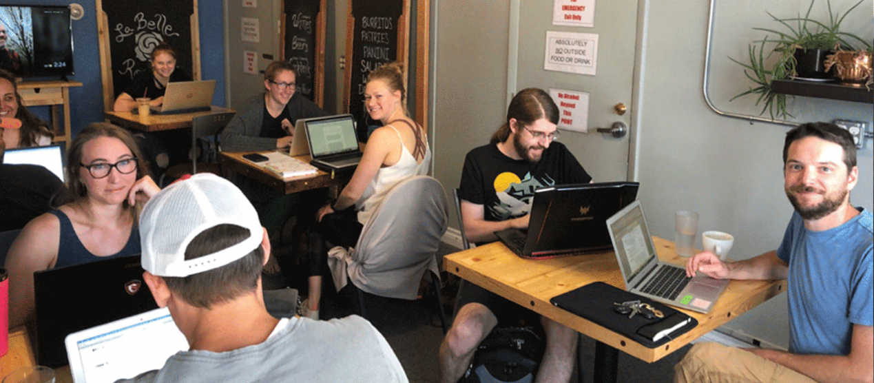 group of faculty and graduate students in coffee shop