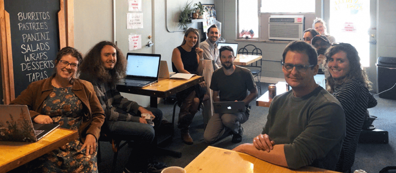 smiling science and math faculty and graduate students in coffee shop